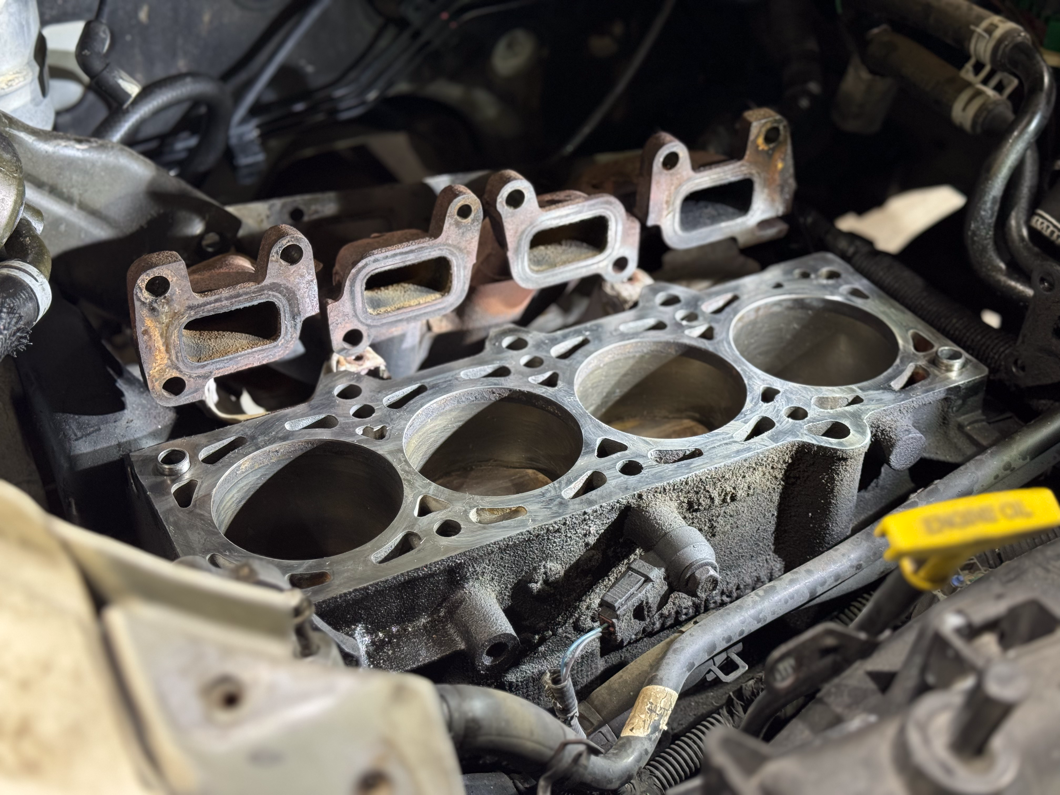 A photo of an engine in a PT Cruiser dissasembled to the block revealing the pistons